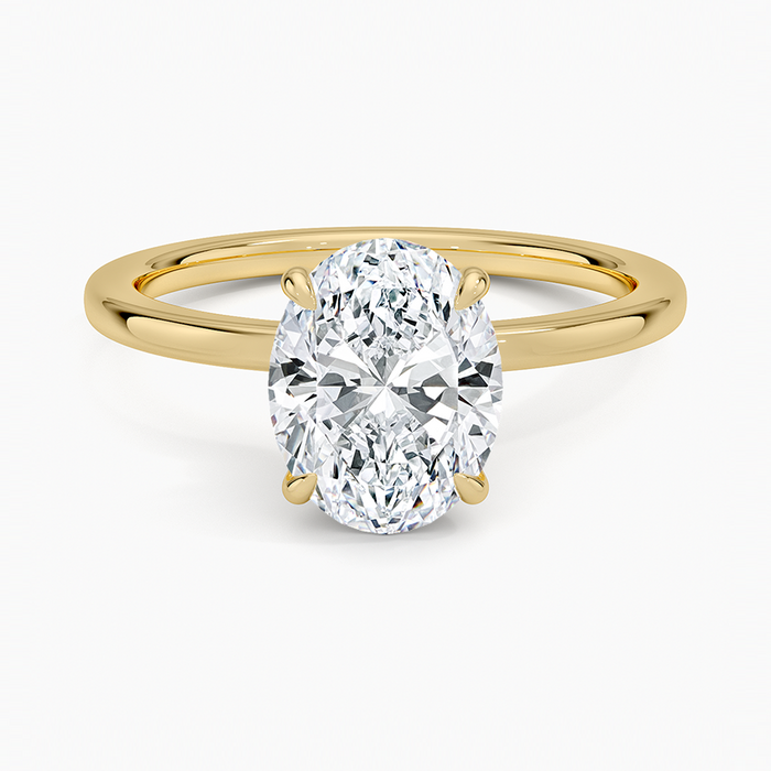 Oval moissanite secret halo solitaire engagement ring in yellow gold, top view