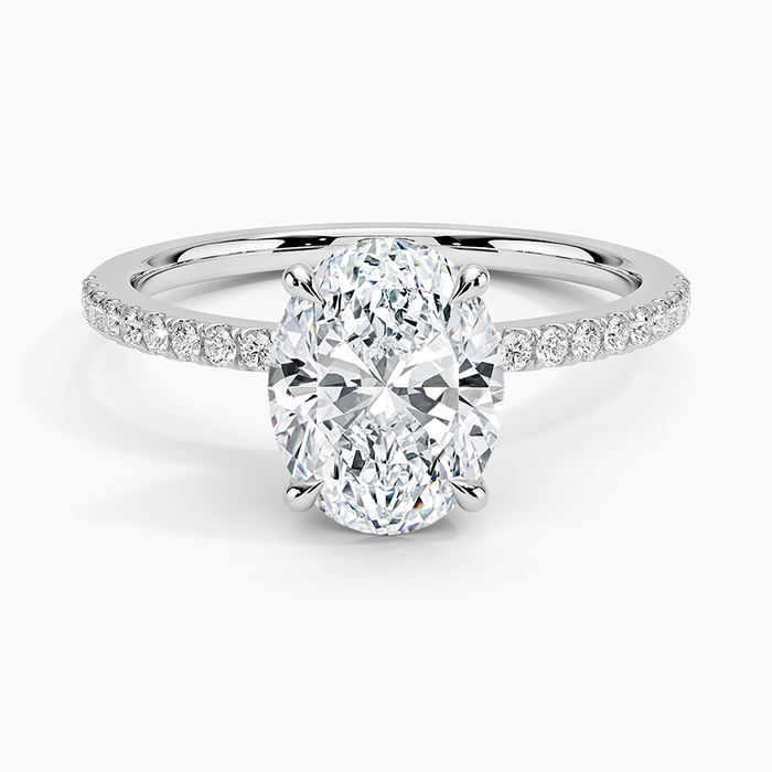 Oval moissanite with slim micropave shoulders in white gold, top view