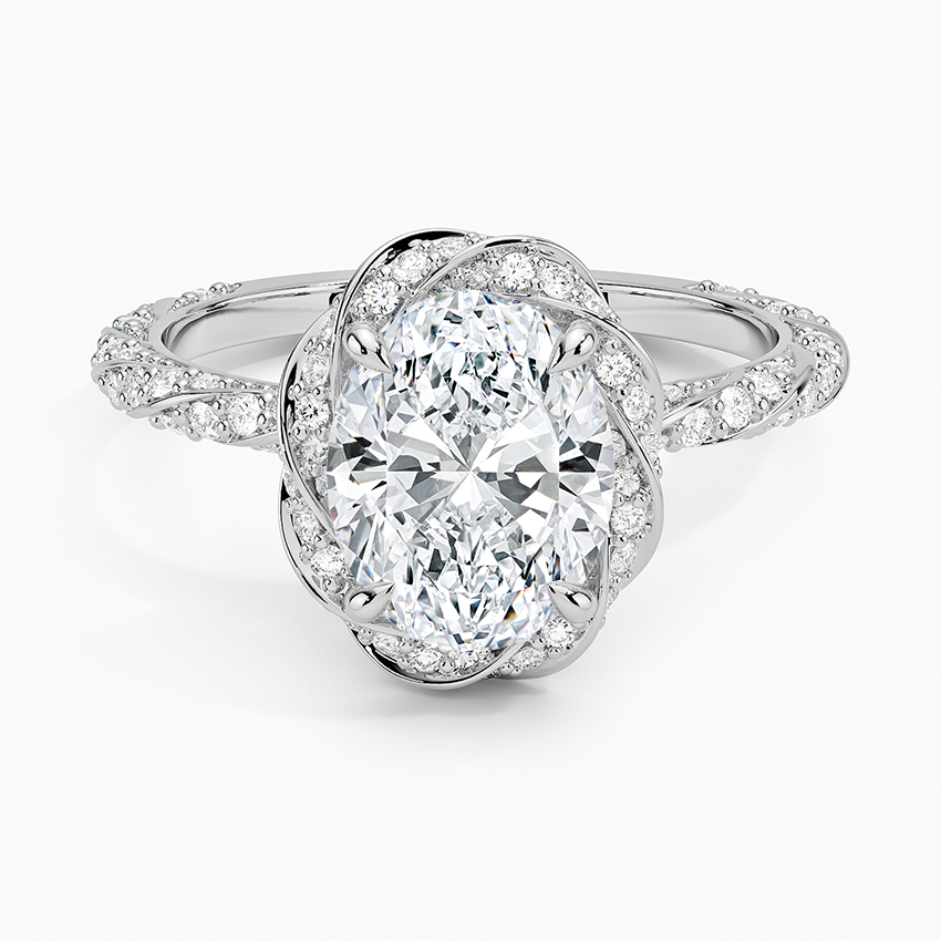 Oval moissanite inside a swirling pave knot halo in white gold, top view