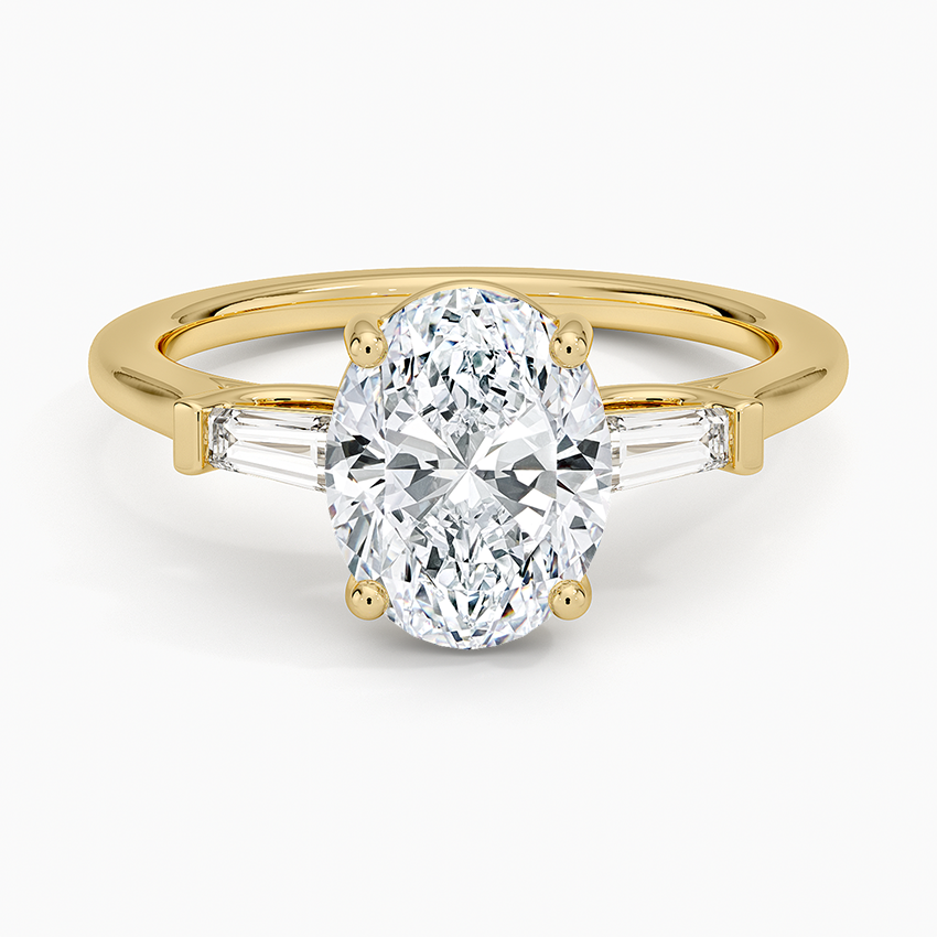 Oval moissanite with long tapered baguette sides in yellow gold, top view