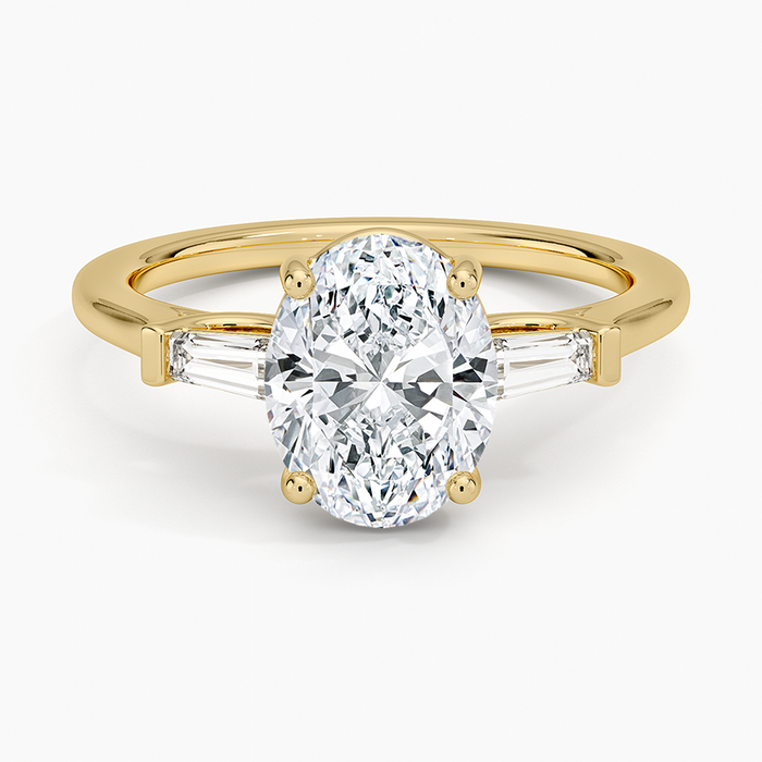 Oval moissanite with long tapered baguette sides in yellow gold, top view