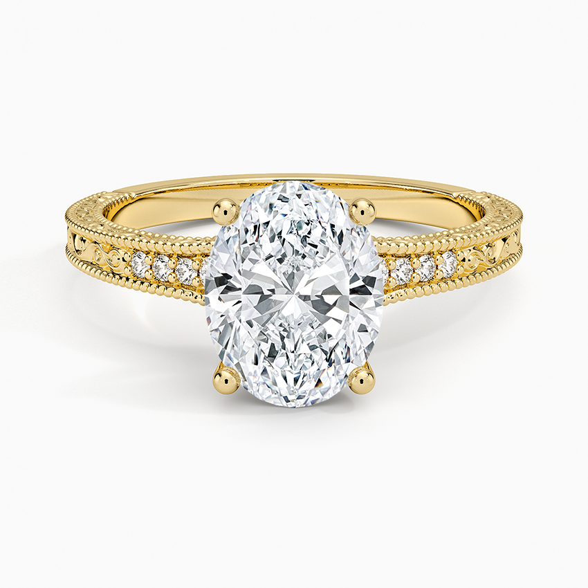 Oval moissanite on an engraved milgrain edged yellow gold band, top view