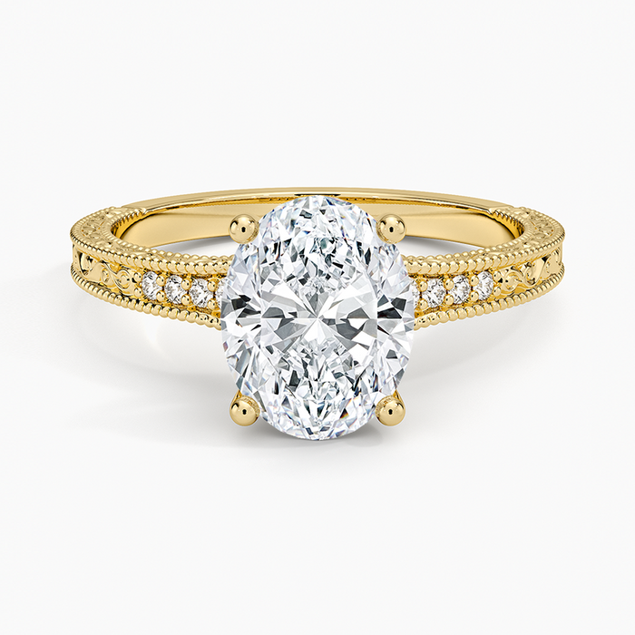 Oval moissanite on an engraved milgrain edged yellow gold band, top view