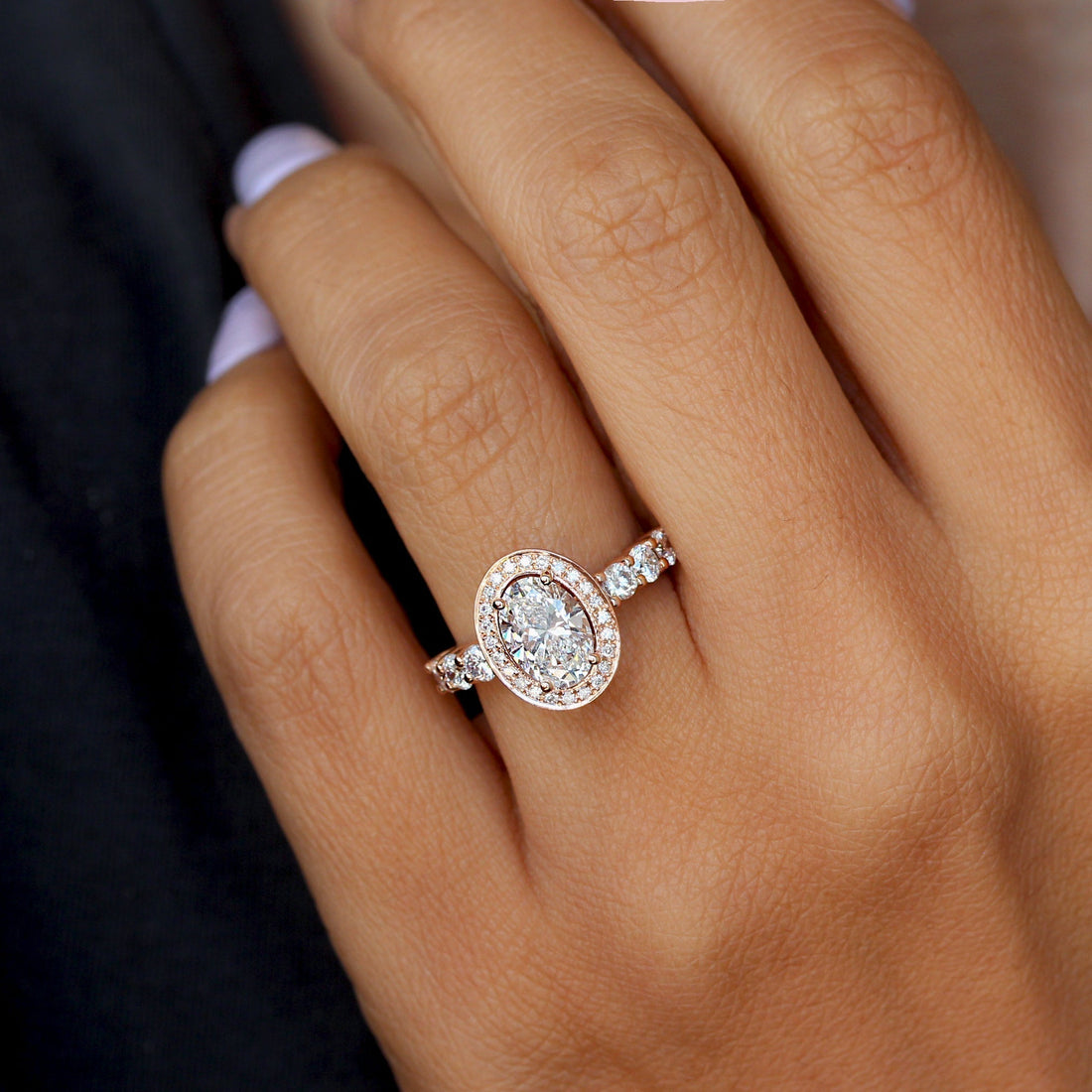 Oval cut moissanite vintage halo engagement ring with graduated round shoulders in rose gold