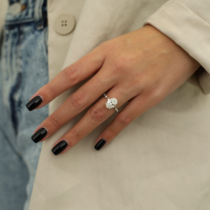 Oval cut moissanite engagement ring with widely spaced accents on a hairline white gold band, view 2