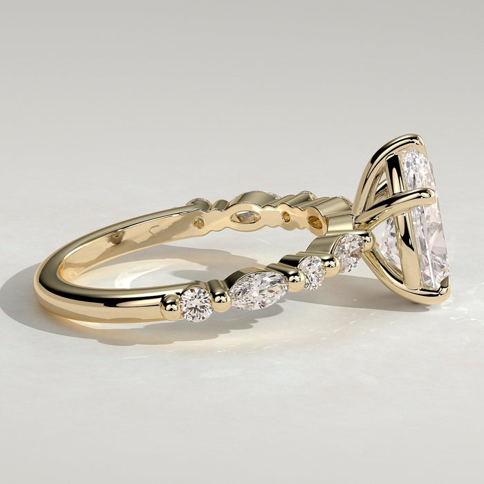 Pear cut moissanite engagement ring with alternating marquise and round accents in yellow gold, view 2