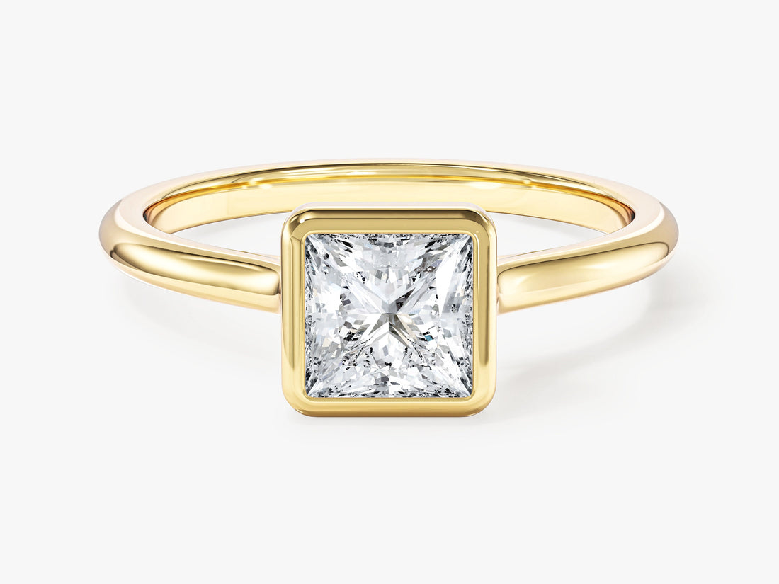 Dainty princess moissanite bezel engagement ring in yellow gold, front view