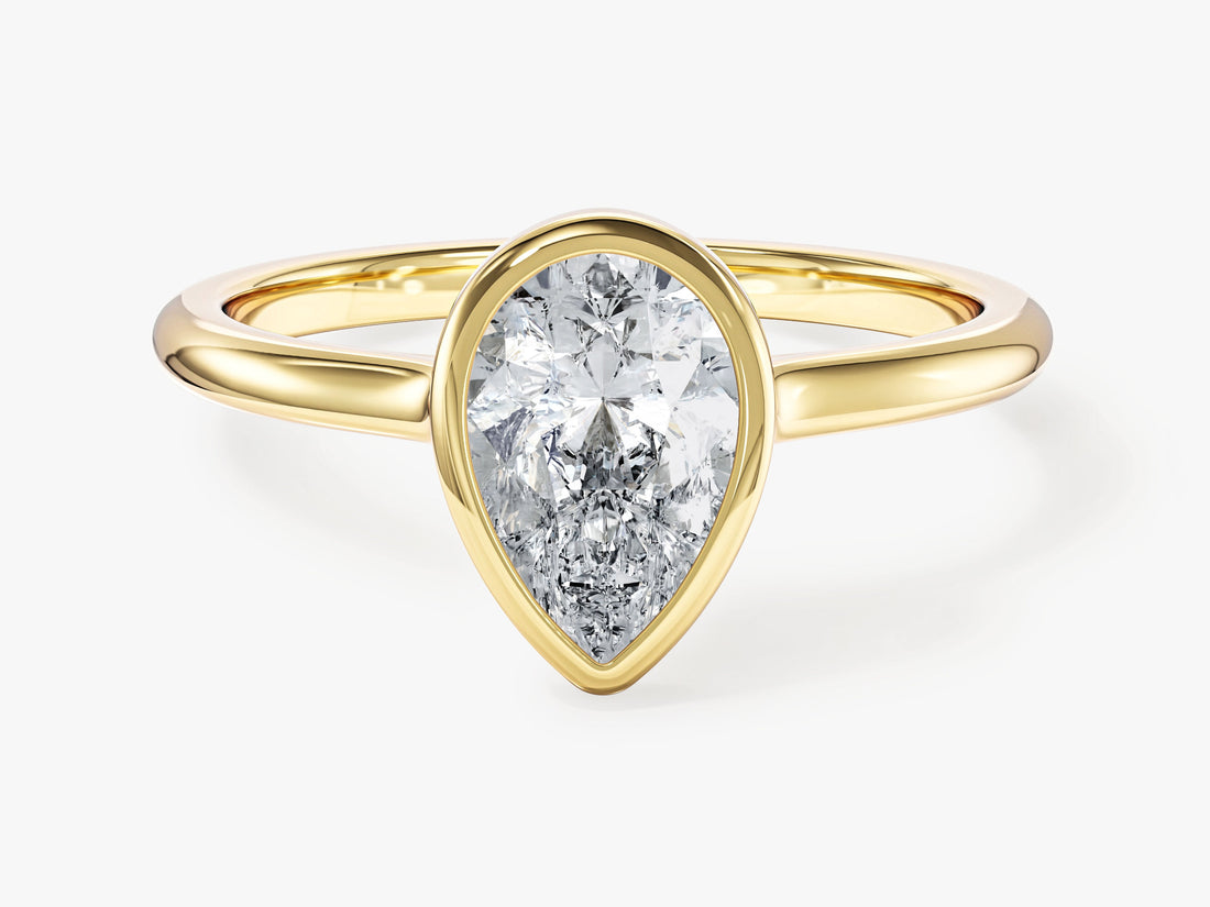 Pear cut moissanite bezel set solitaire engagement ring in yellow gold, front view