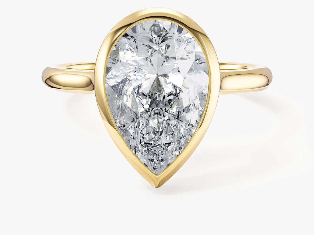 Large pear moissanite bezel engagement ring in yellow gold, front view