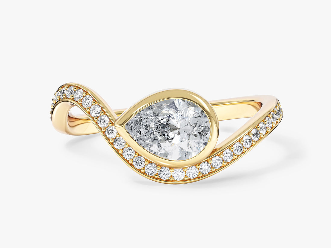 East west pear moissanite bezel engagement ring with curved pave band in 14K yellow gold, front view