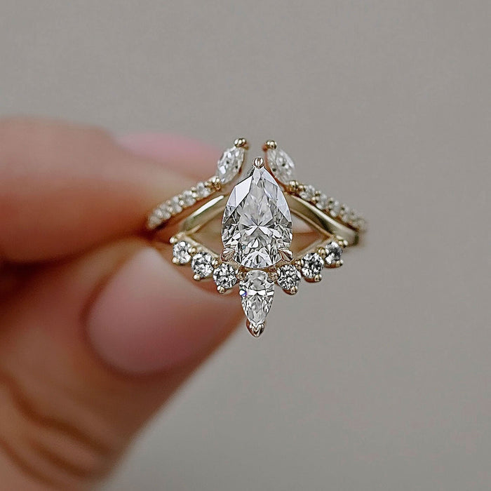 Pear cut moissanite crown cluster engagement ring in yellow gold
