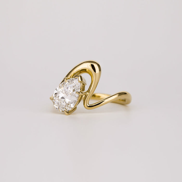 Pear cut moissanite angled curved shank solitaire engagement ring in yellow gold, view 2