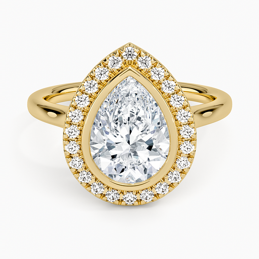 Pear cut moissanite bezel set pave halo engagement ring in yellow gold, top view