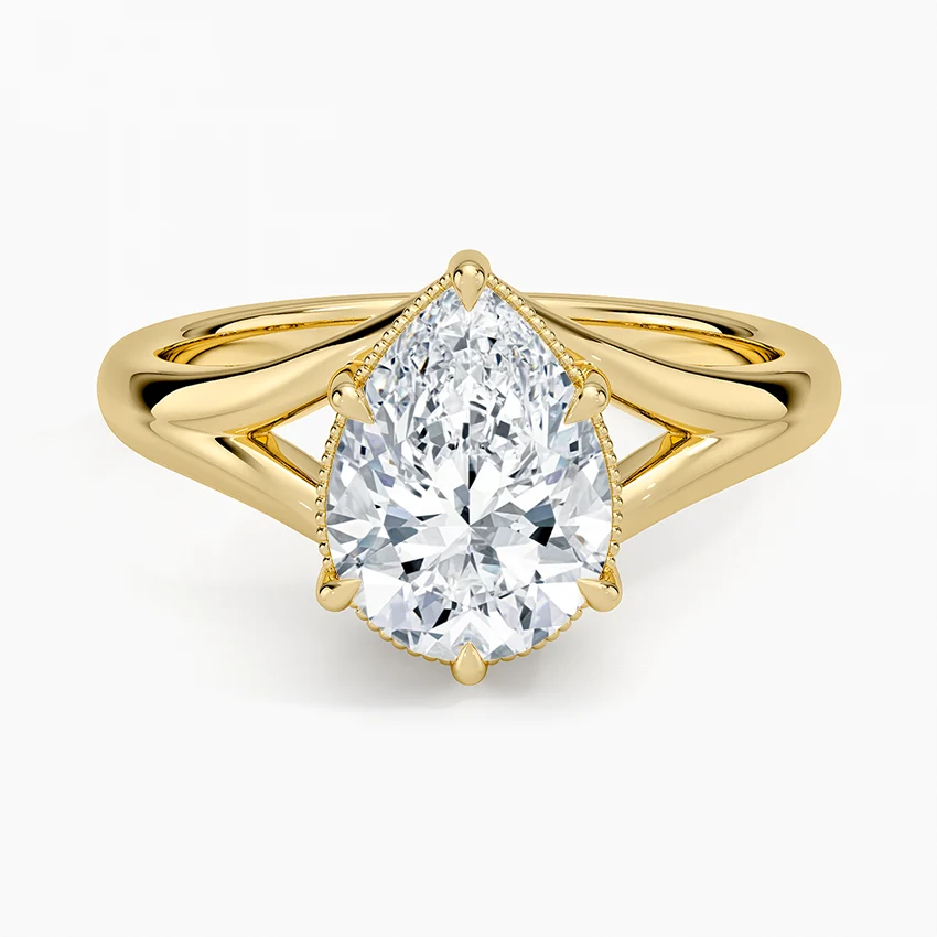 Pear cut moissanite on a polished split shank with milgrain collar in yellow gold, top view