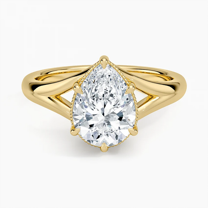 Pear cut moissanite on a polished split shank with milgrain collar in yellow gold, top view