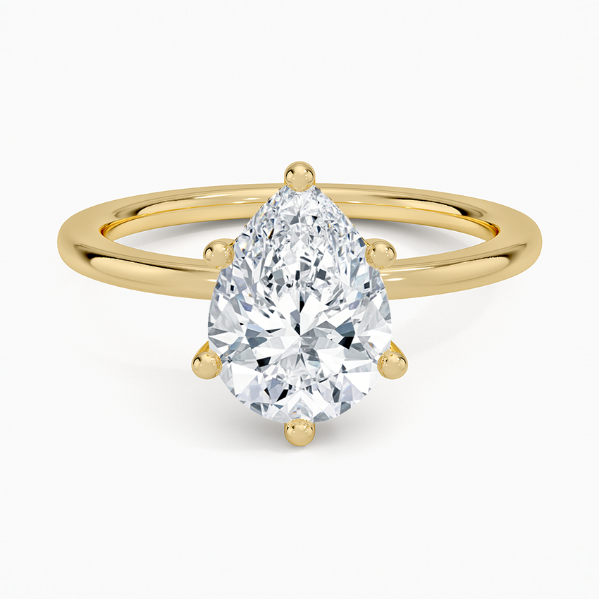 Pear cut moissanite in six claws on a plain slim round band in yellow gold, top view
