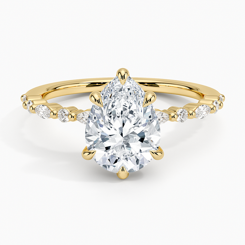 Pear cut moissanite claw set marquise and round engagement ring in yellow gold, top view
