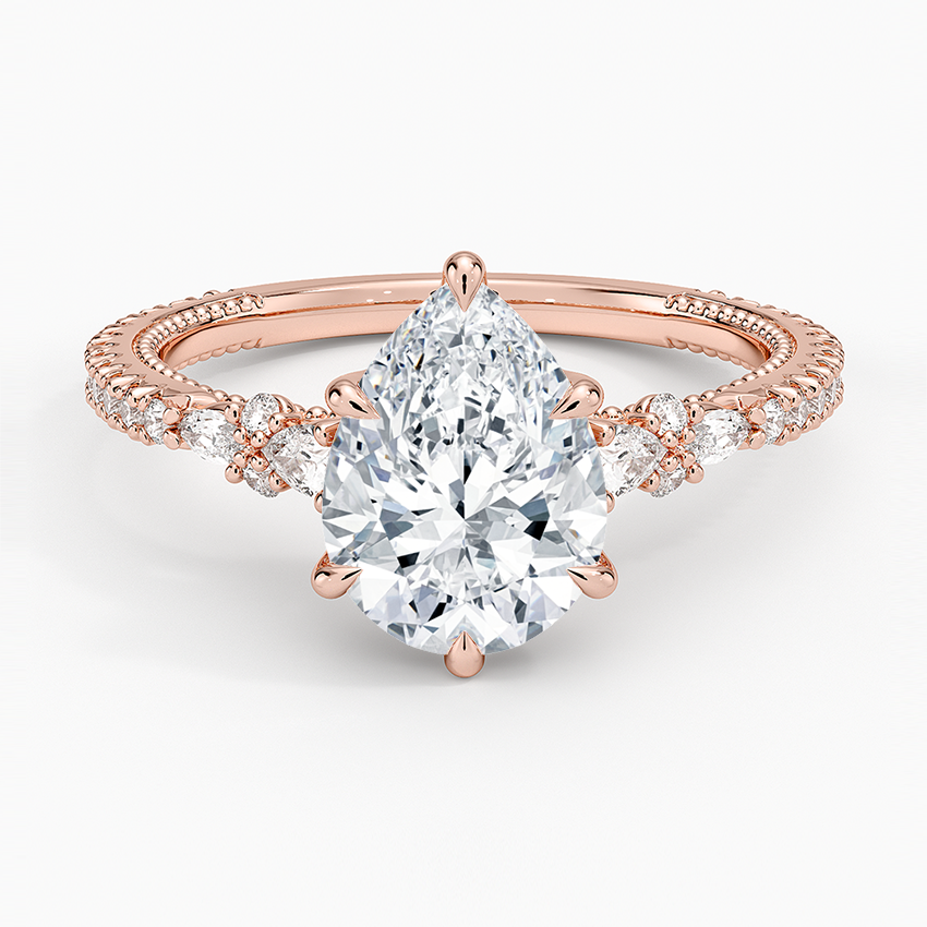 Pear cut moissanite cluster side full pave engagement ring in rose gold, top view