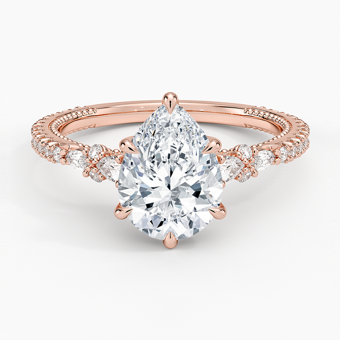 Pear cut moissanite cluster side full pave engagement ring in rose gold, top view