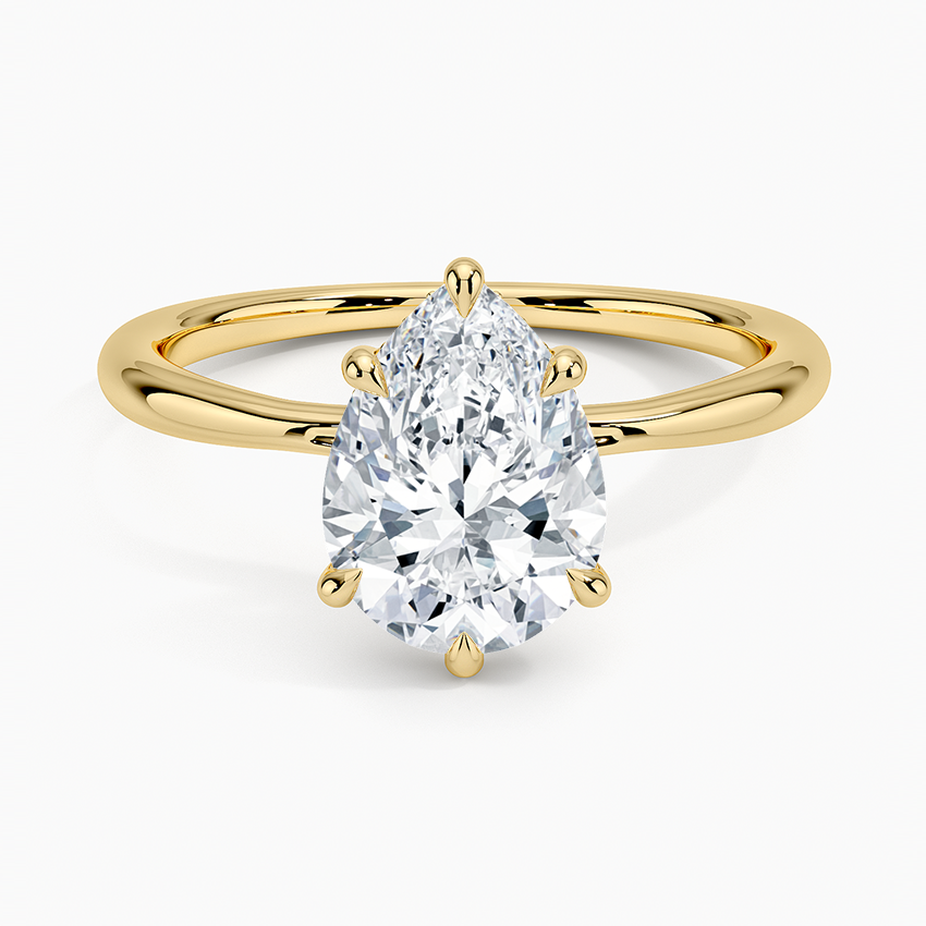 Pear cut moissanite hidden halo engagement ring in yellow gold, top view