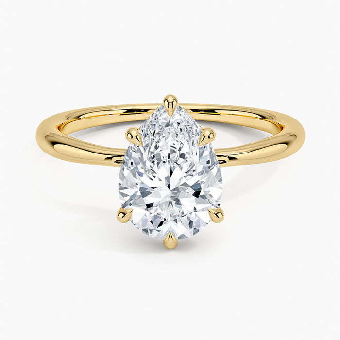 Pear cut moissanite hidden halo engagement ring in yellow gold, top view