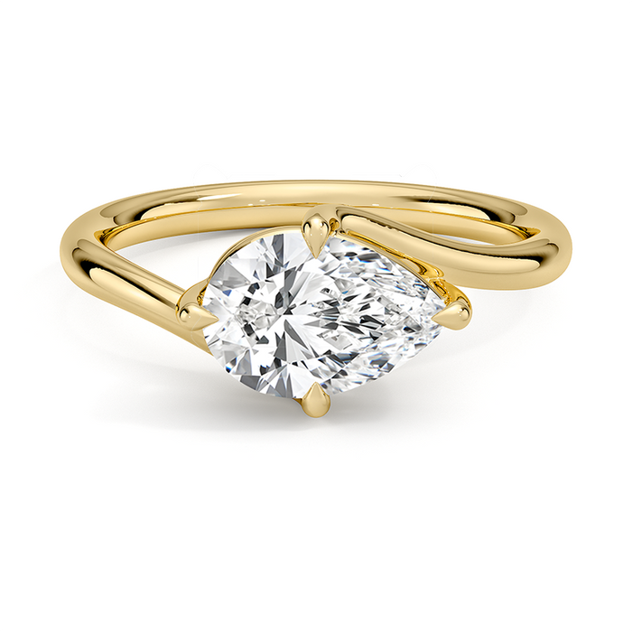 East west set pear cut moissanite on an open bypass shank in yellow gold, top view