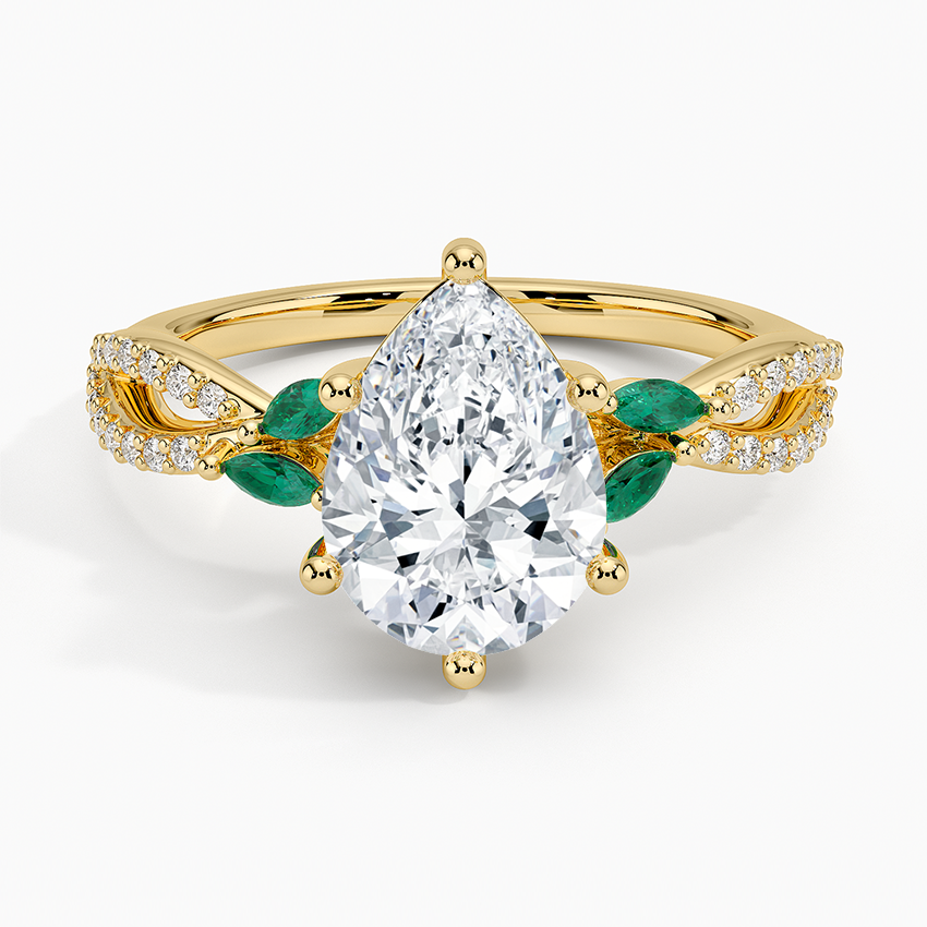 Pear cut moissanite twisted vine engagement ring with green marquise emerald leaves in yellow gold, top view