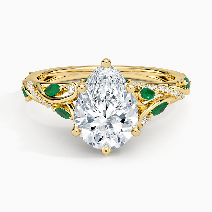 Pear cut moissanite with marquise green emerald leaves on pave vine branches in yellow gold, top view