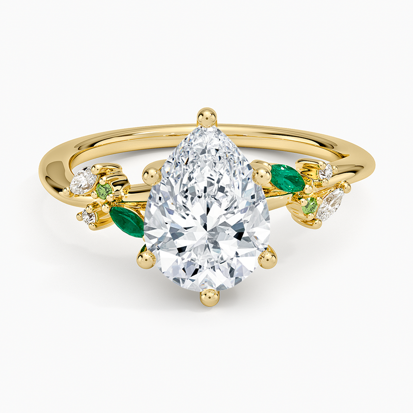 Pear cut moissanite with alternating green emerald and colorless marquise leaves in yellow gold, top view