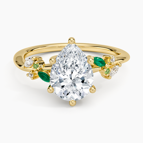 Pear cut moissanite with alternating green emerald and colorless marquise leaves in yellow gold, top view