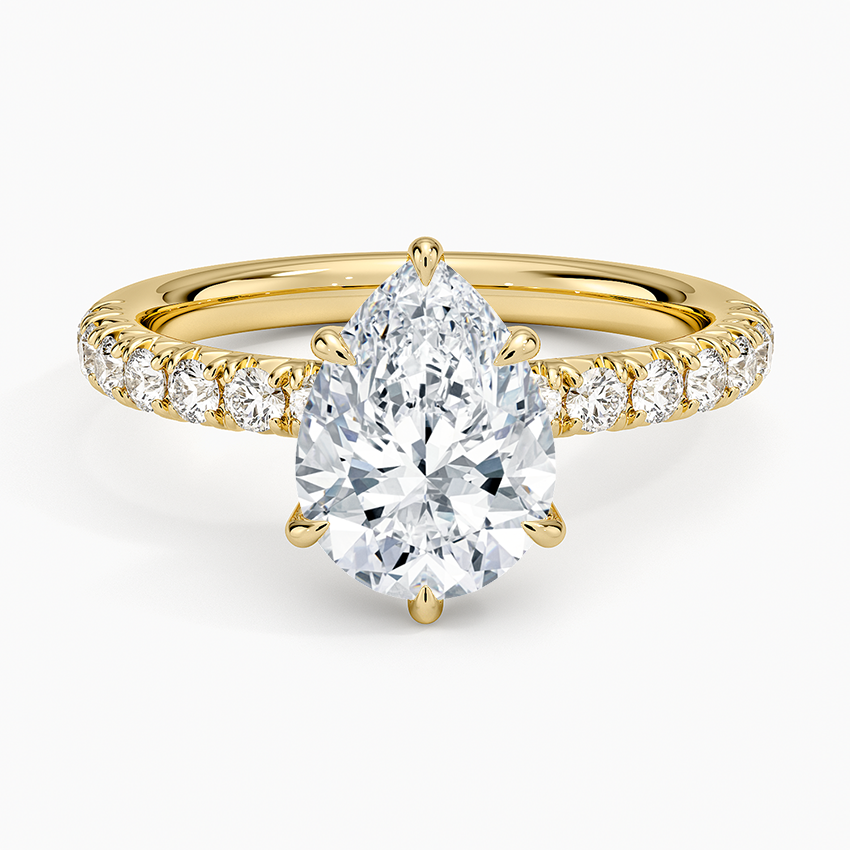 Pear cut moissanite French pave engagement ring in yellow gold, top view