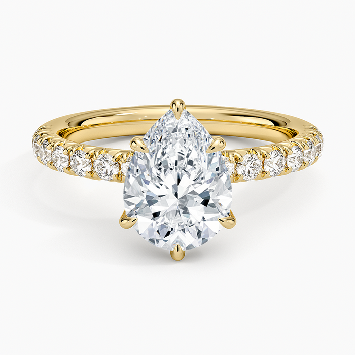 Pear cut moissanite French pave engagement ring in yellow gold, top view
