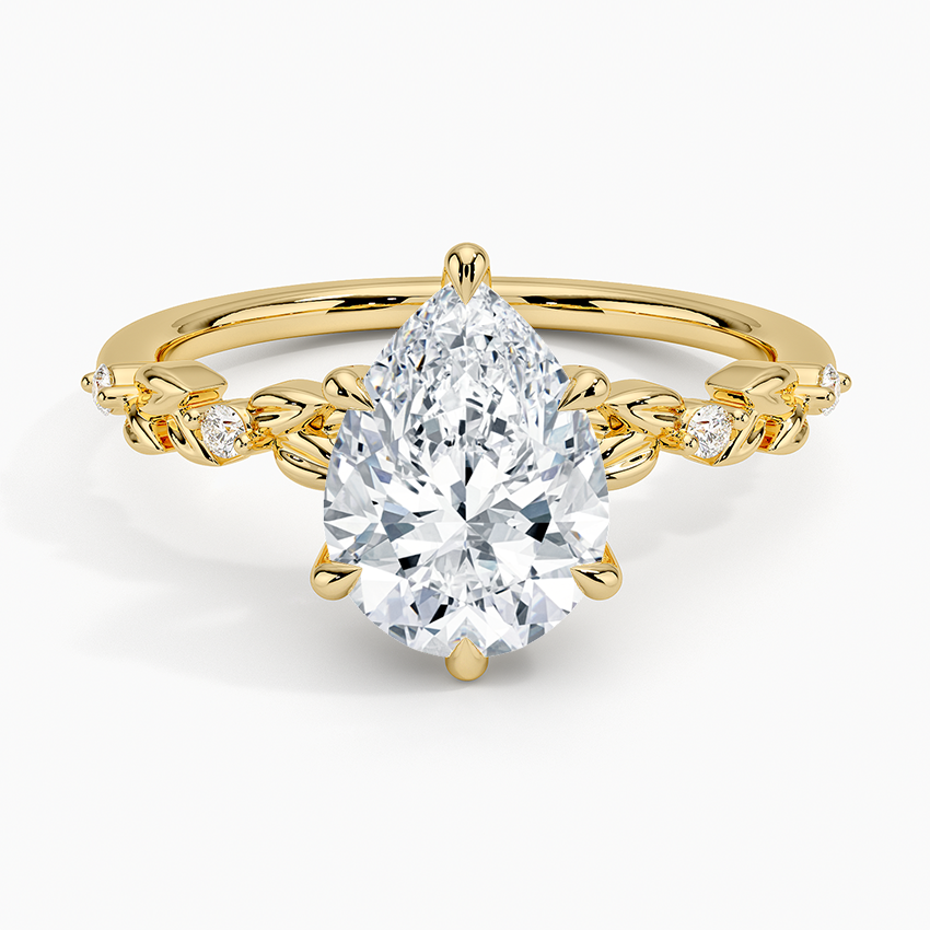 Pear cut moissanite gold leaf and bezel accent engagement ring in yellow gold, top view