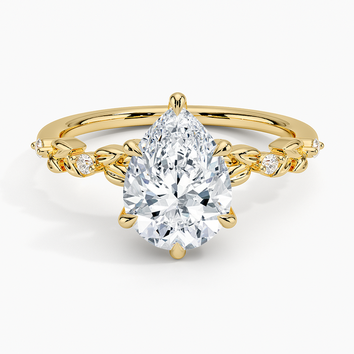 Pear cut moissanite gold leaf and bezel accent engagement ring in yellow gold, top view