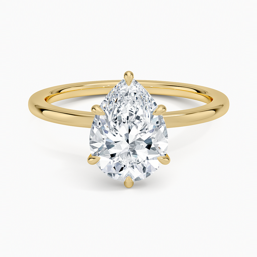 Pear cut moissanite hidden halo engagement ring in yellow gold, top view