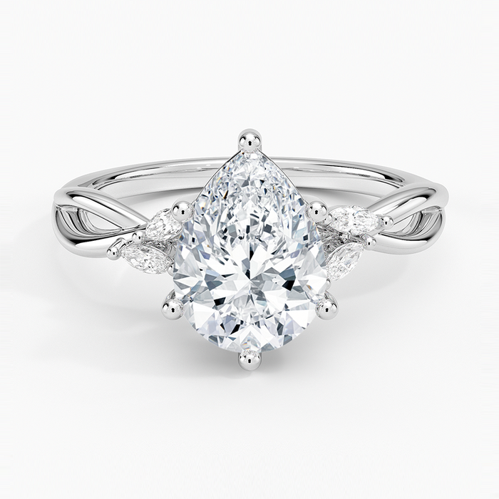 Pear cut moissanite on an infinity crossover shank with marquise petal accents in white gold, top view