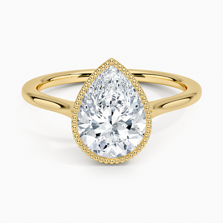 Pear cut moissanite milgrain bezel engagement ring in yellow gold, top view