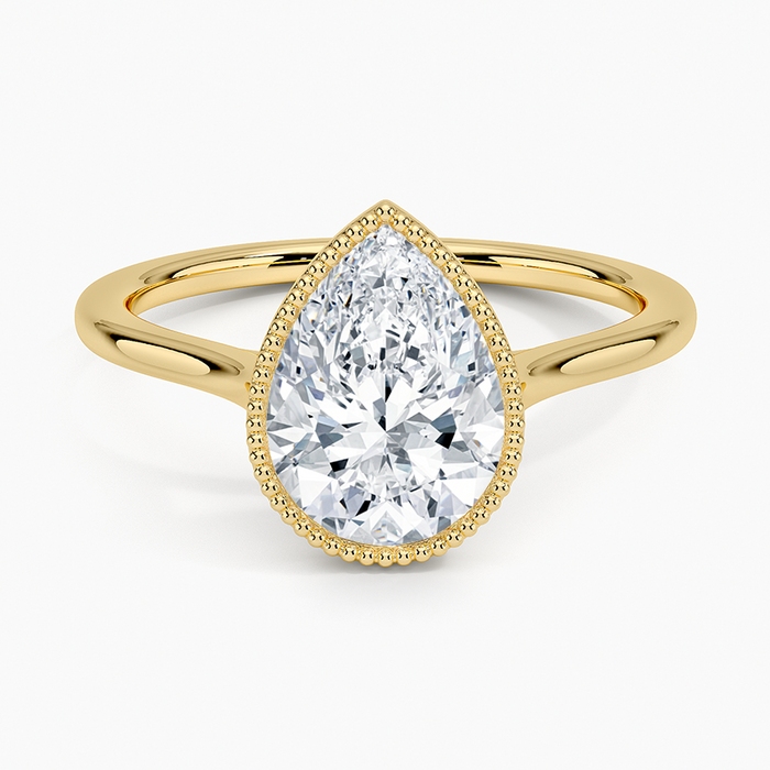 Pear cut moissanite milgrain bezel engagement ring in yellow gold, top view