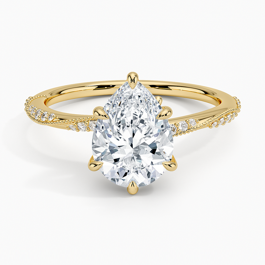 Pear cut moissanite with graduated scalloped milgrain pave shoulders in yellow gold, top view