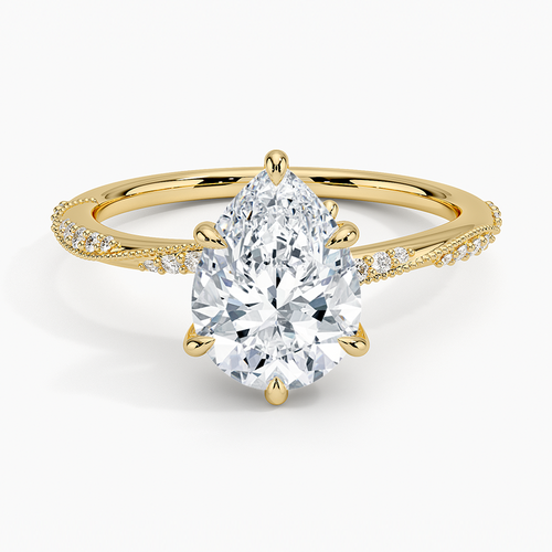 Pear cut moissanite with graduated scalloped milgrain pave shoulders in yellow gold, top view