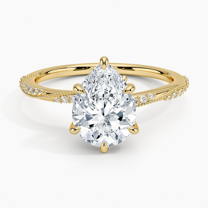 Pear cut moissanite with graduated scalloped milgrain pave shoulders in yellow gold, top view
