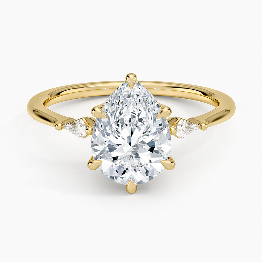 Pear cut moissanite three stone engagement ring with matching pear side stones in yellow gold, top view