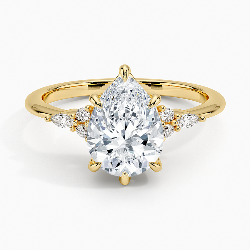 Pear cut moissanite petite marquise and round cluster engagement ring in yellow gold, top view