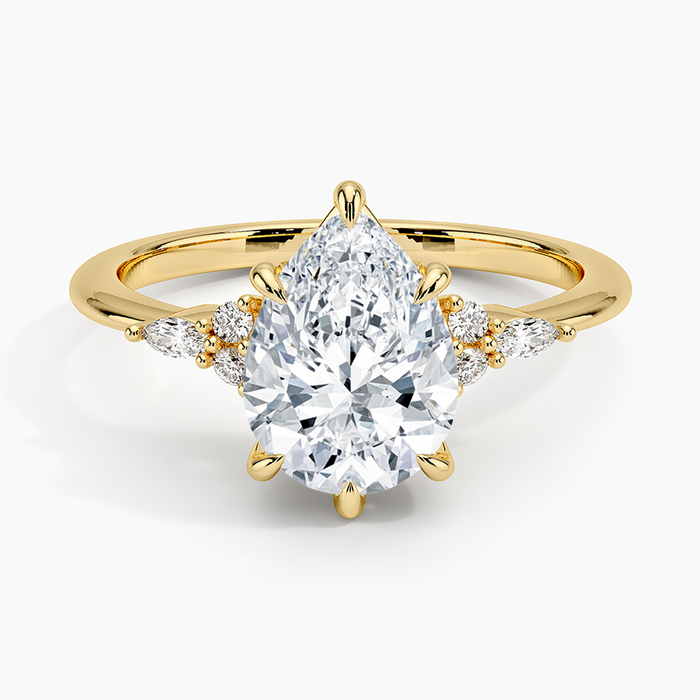Pear cut moissanite petite marquise and round cluster engagement ring in yellow gold, top view