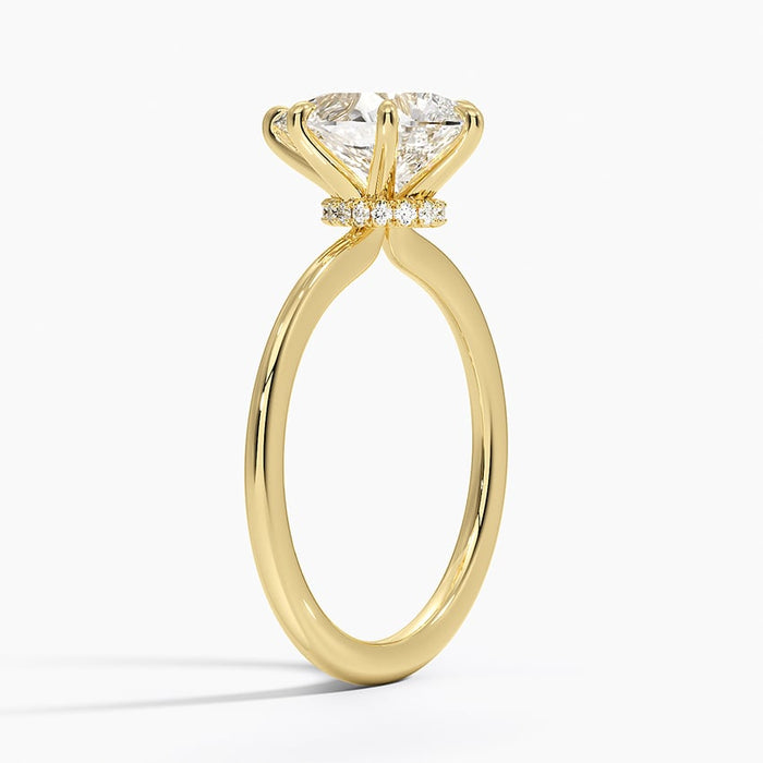 Side view showing the hidden halo of small accents under the pear setting