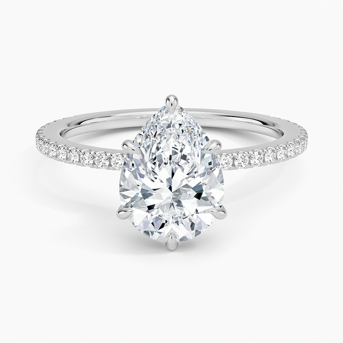 Pear cut moissanite scalloped pave hidden halo engagement ring in white gold, top view
