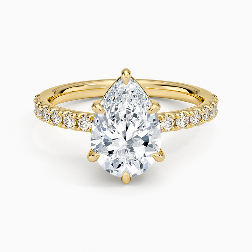Pear cut moissanite shared prong pave engagement ring in yellow gold, top view