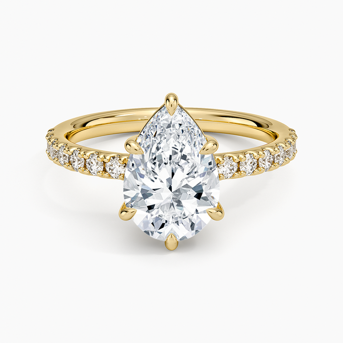 Pear cut moissanite shared prong pave engagement ring in yellow gold, top view