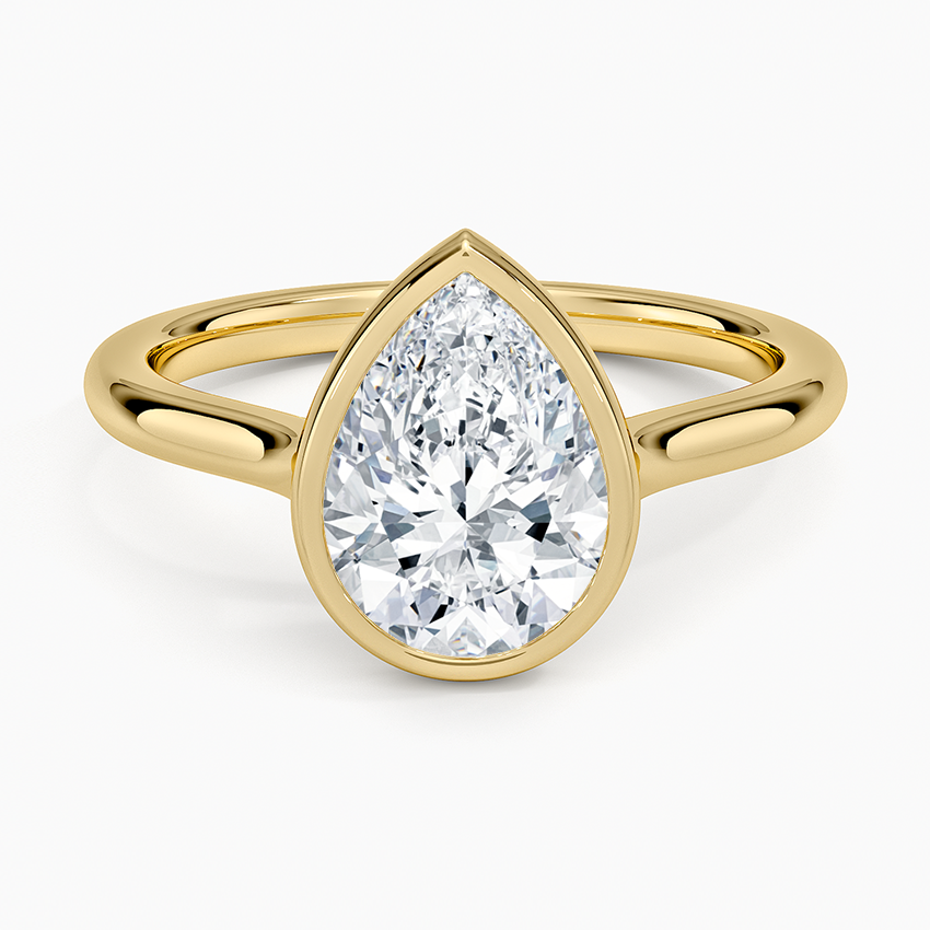 Pear cut moissanite in a fine bezel on a slim band in yellow gold, top view