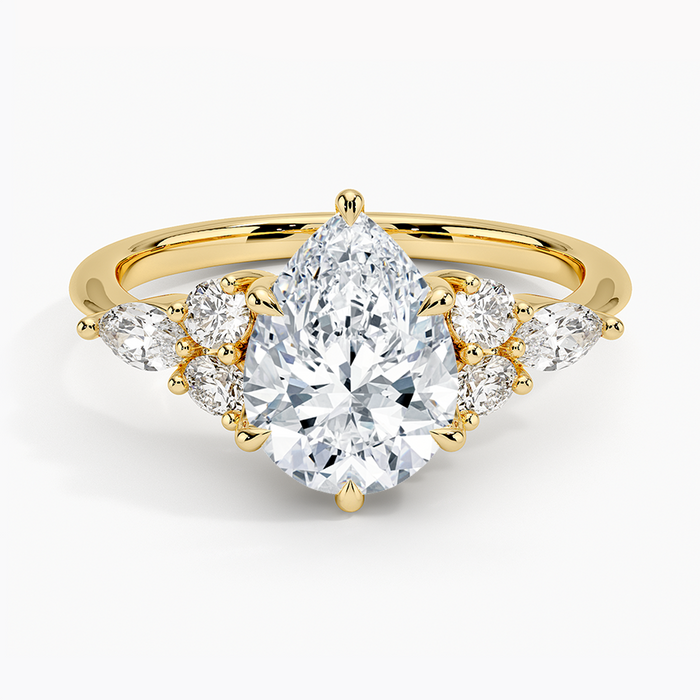 Pear cut moissanite with mirrored marquise and round accents on each shoulder in yellow gold, top view